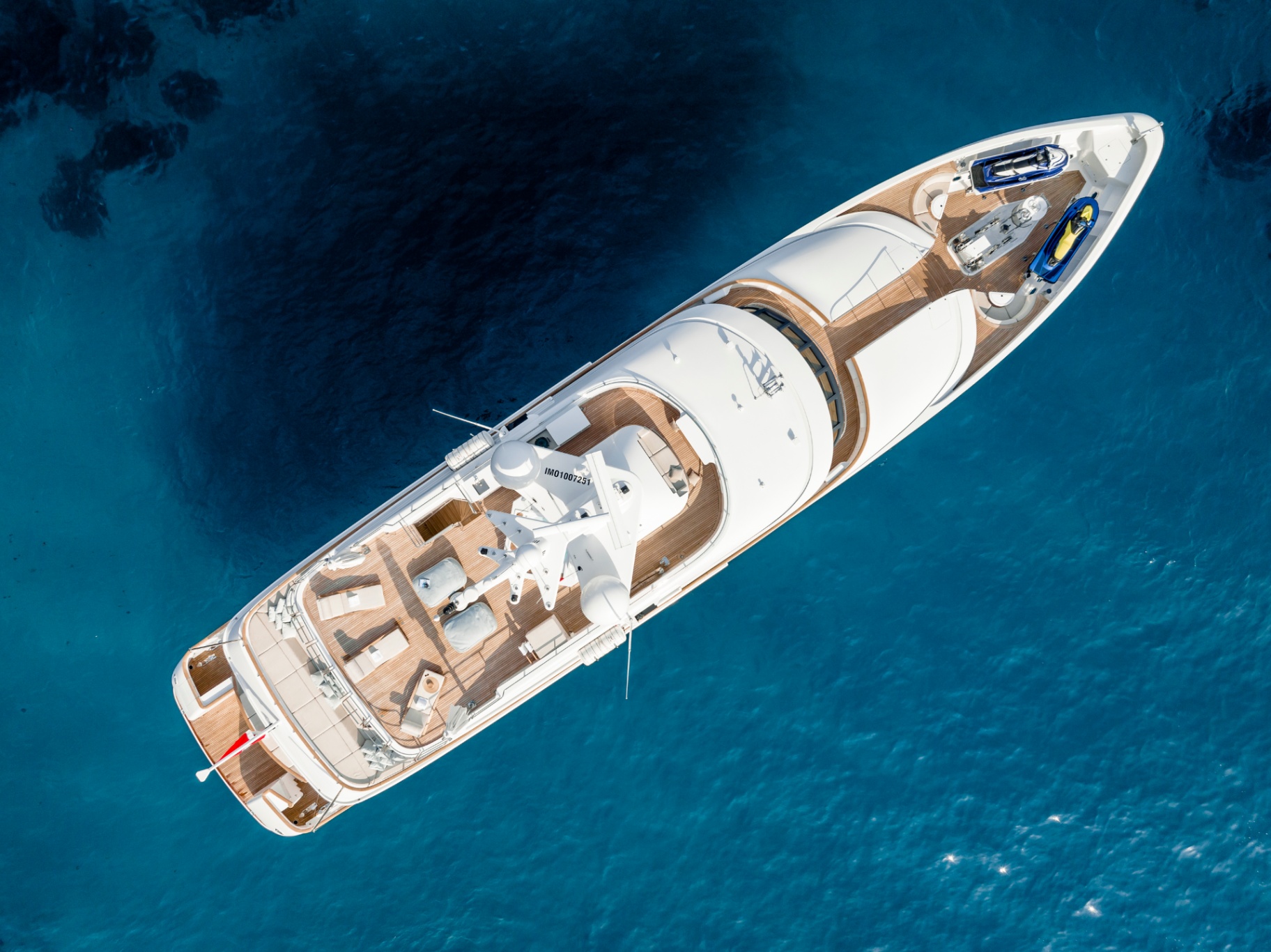 A motor yacht from directly above, tender and toys stowed and ready