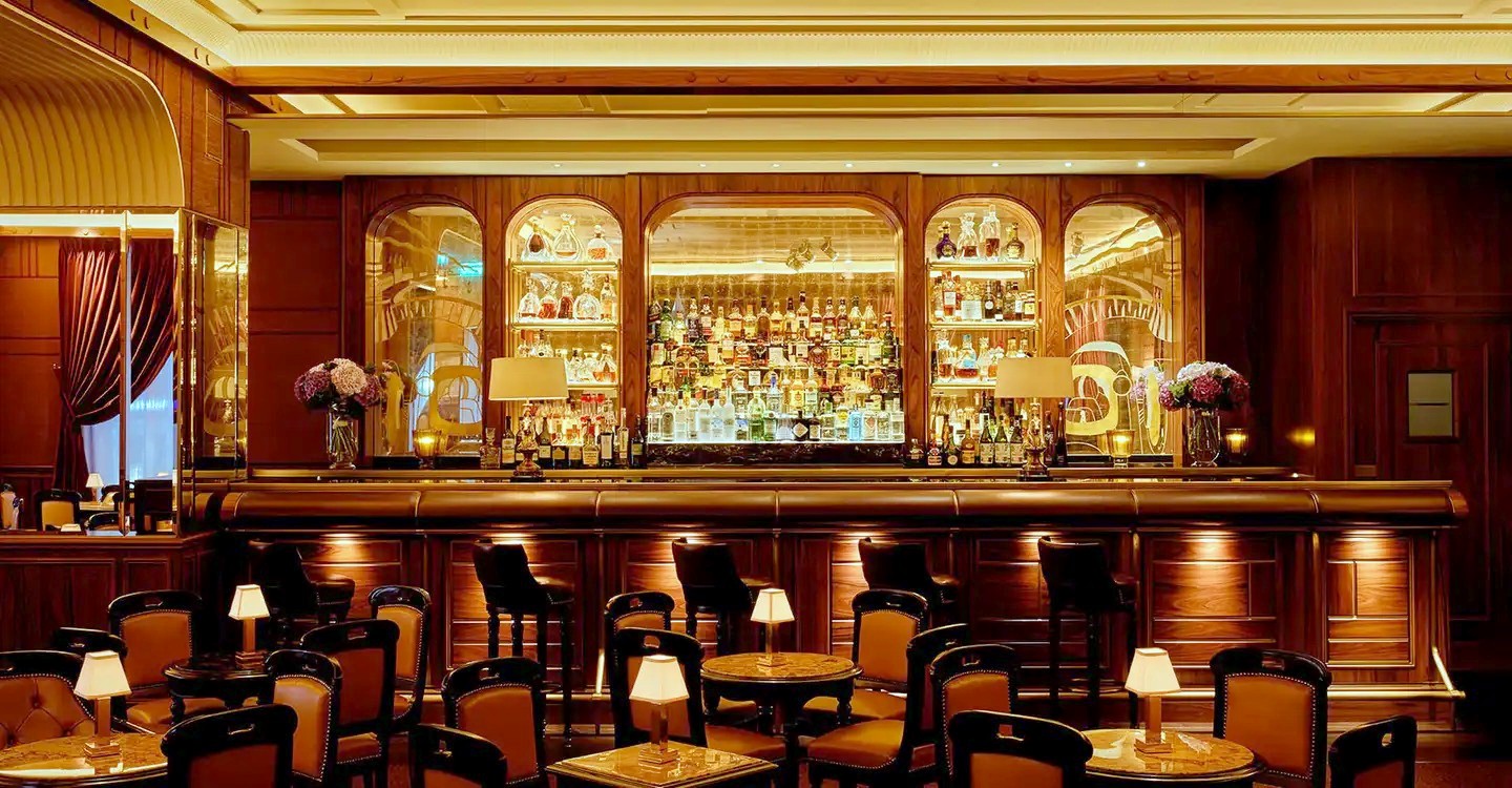 The warmly lit bar at Le Bar Américain, Hôtel de Paris Monte-Carlo