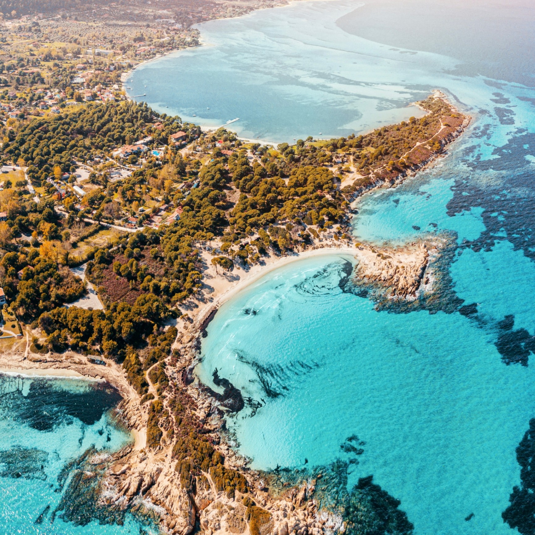 The rocky coastline of Naxos above clear water