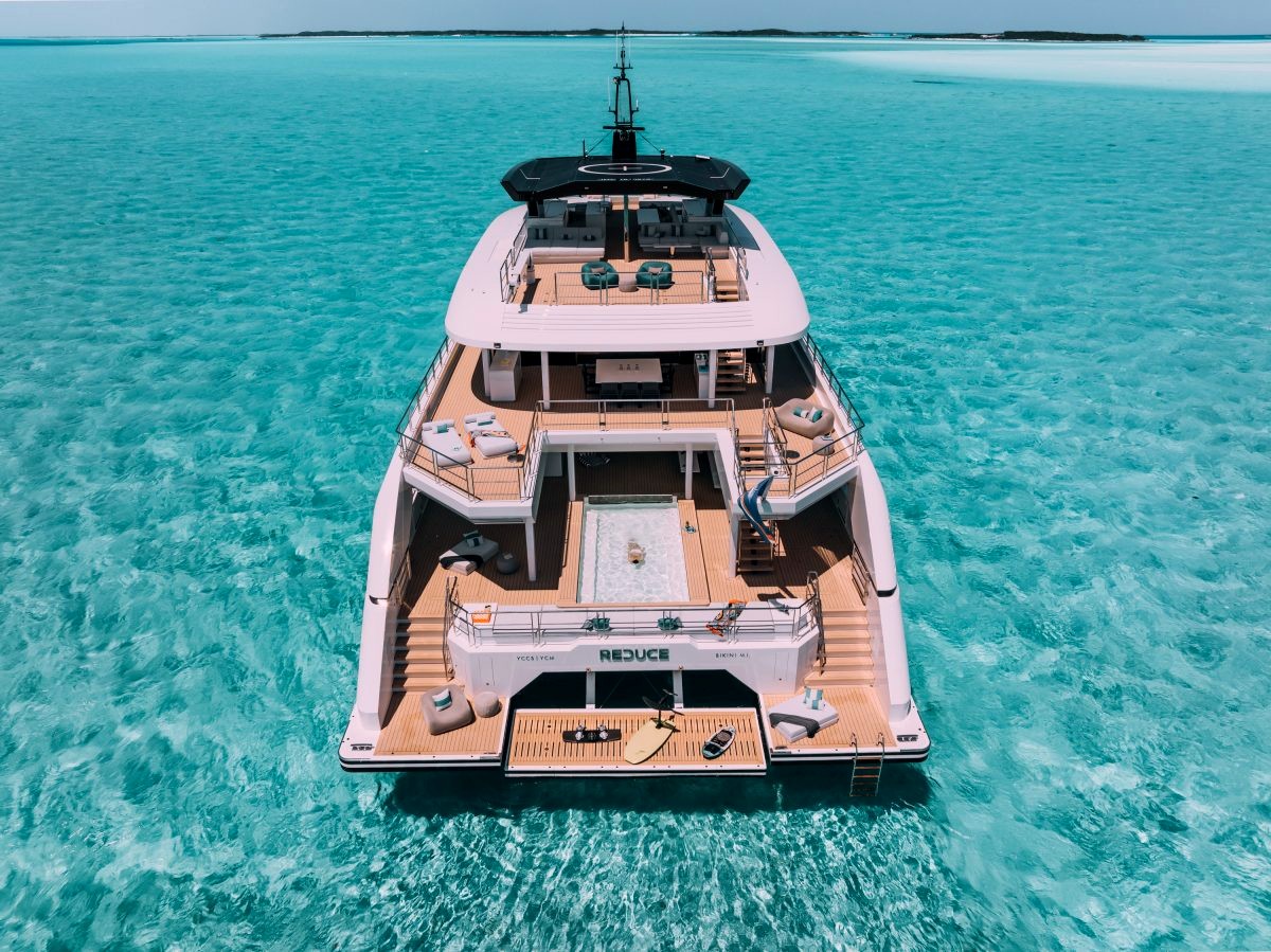 REDUCE at anchor over turquoise water, with her deck pool, lounges and water toys ready. Image: Silver Yachts
