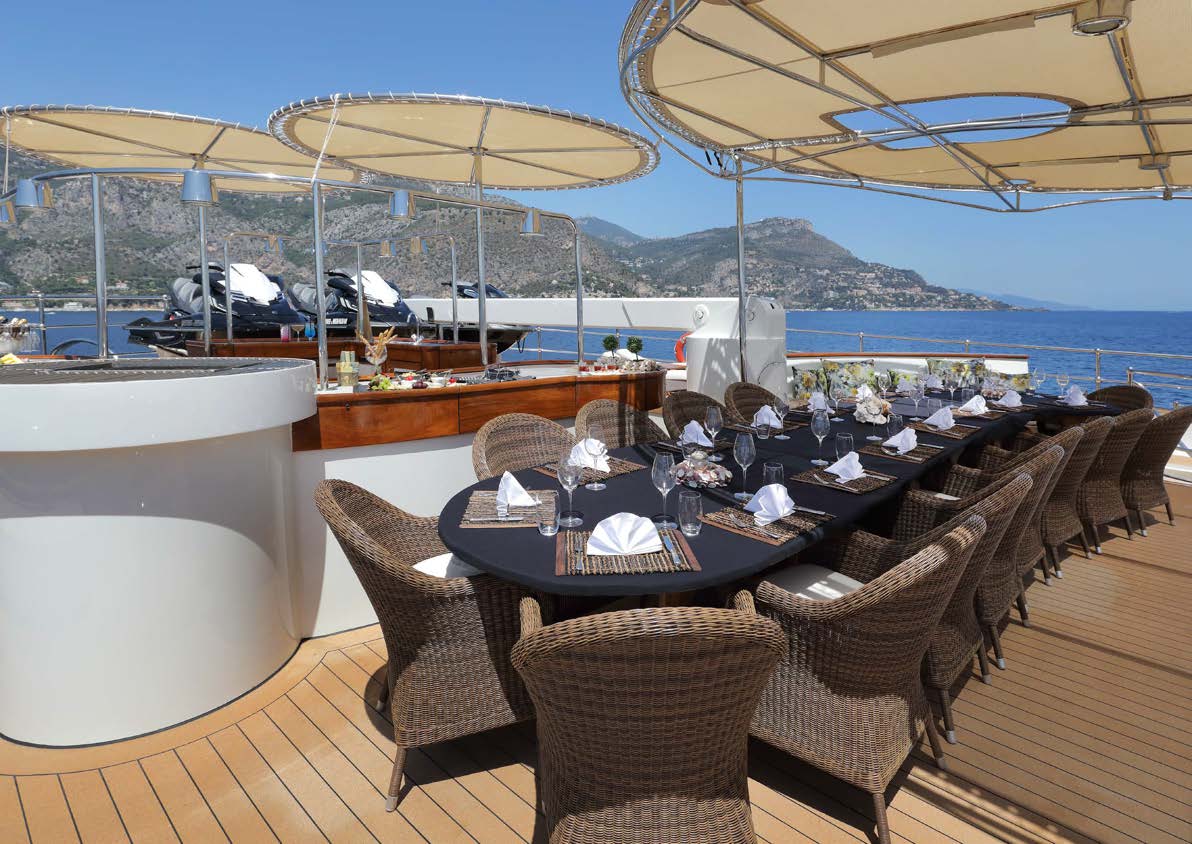 Sherakhan's aft deck dining table set for an evening meal