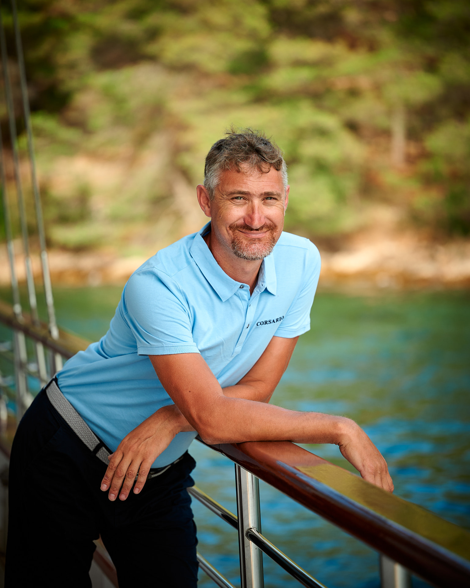 Corsario's captain on deck with the Croatian coast behind