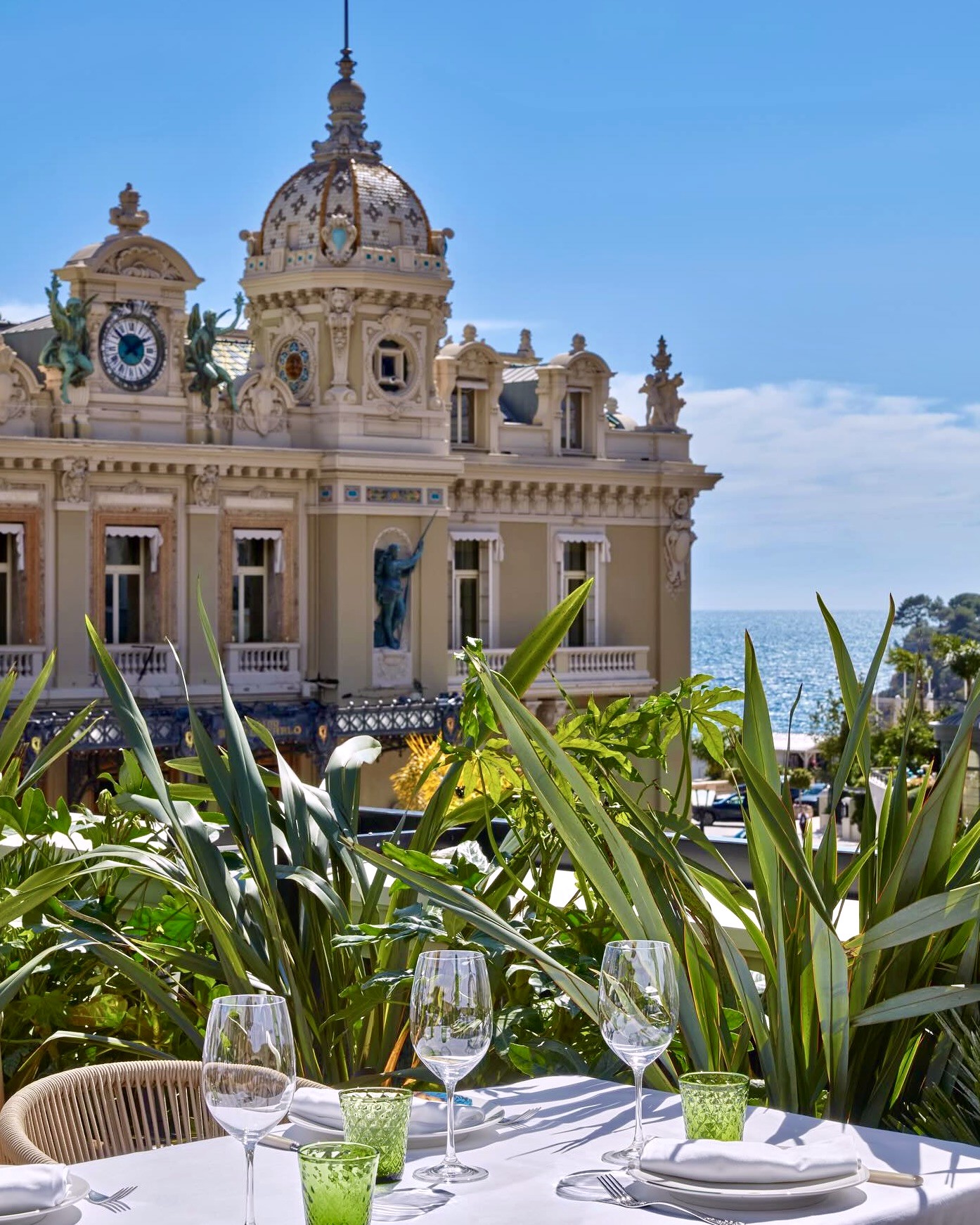 Table laid above Monte Carlo with the casino dome and the sea beyond