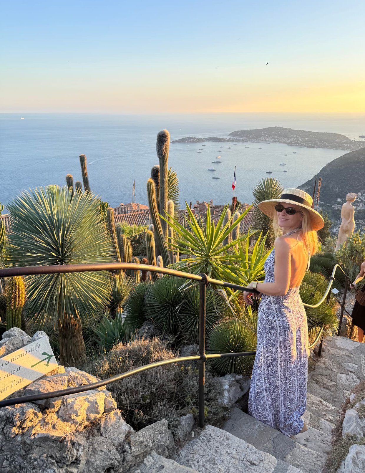 Golden hour in the exotic garden of Èze, cacti above the rooftops and the bay below