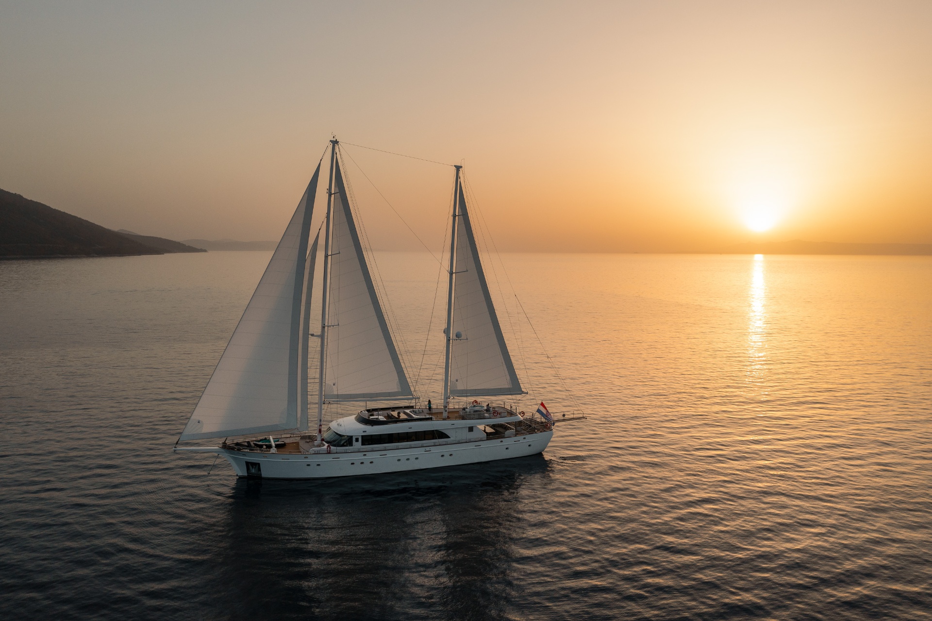 A yacht at anchor in golden evening light
