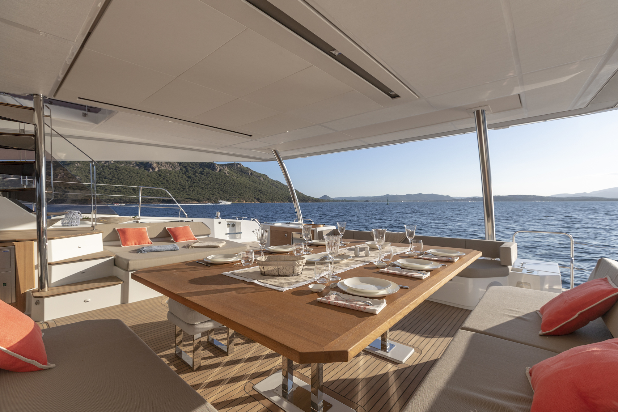 Floramye's shaded aft deck table set for lunch over the sea
