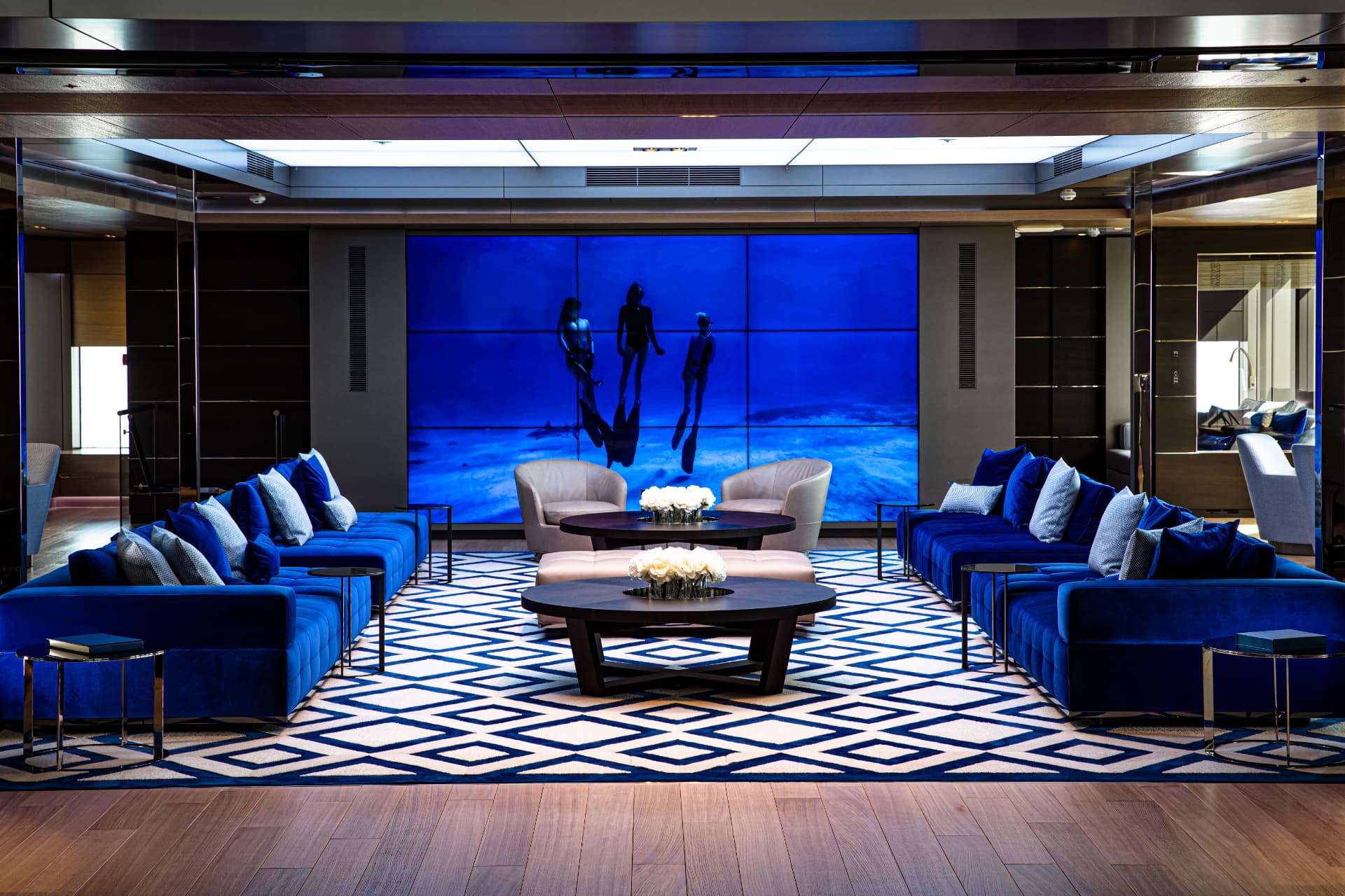 Bold's main salon with cinema wall and blue velvet seating