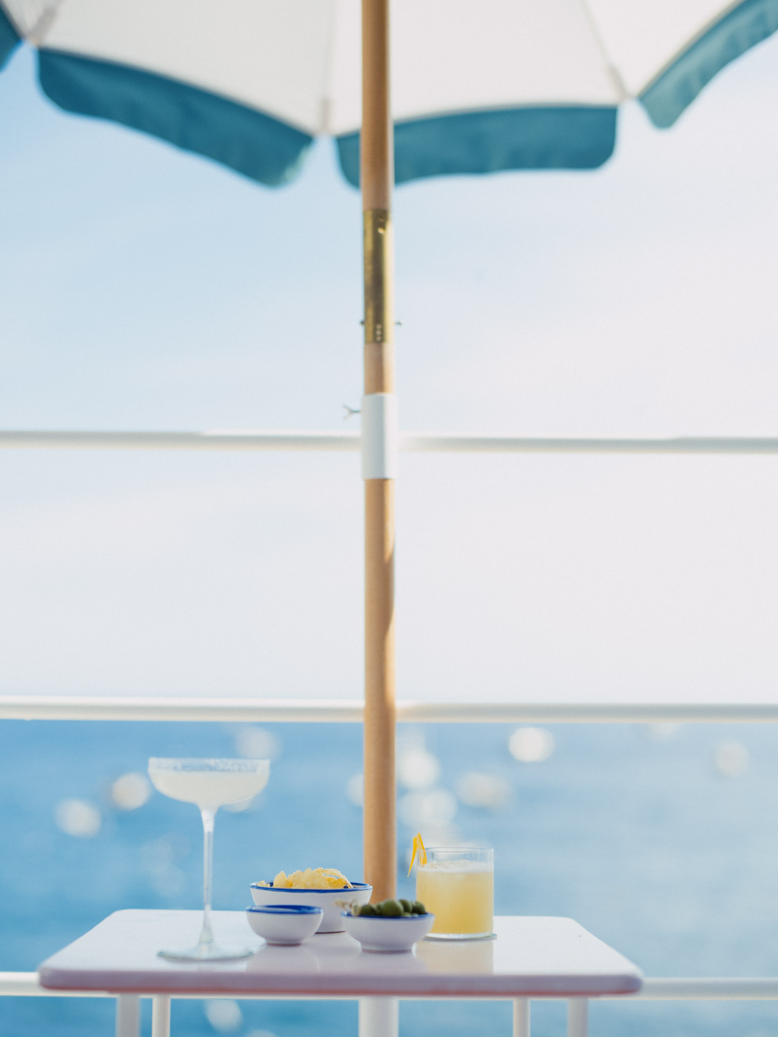 A quiet aperitivo table overlooking the Mediterranean