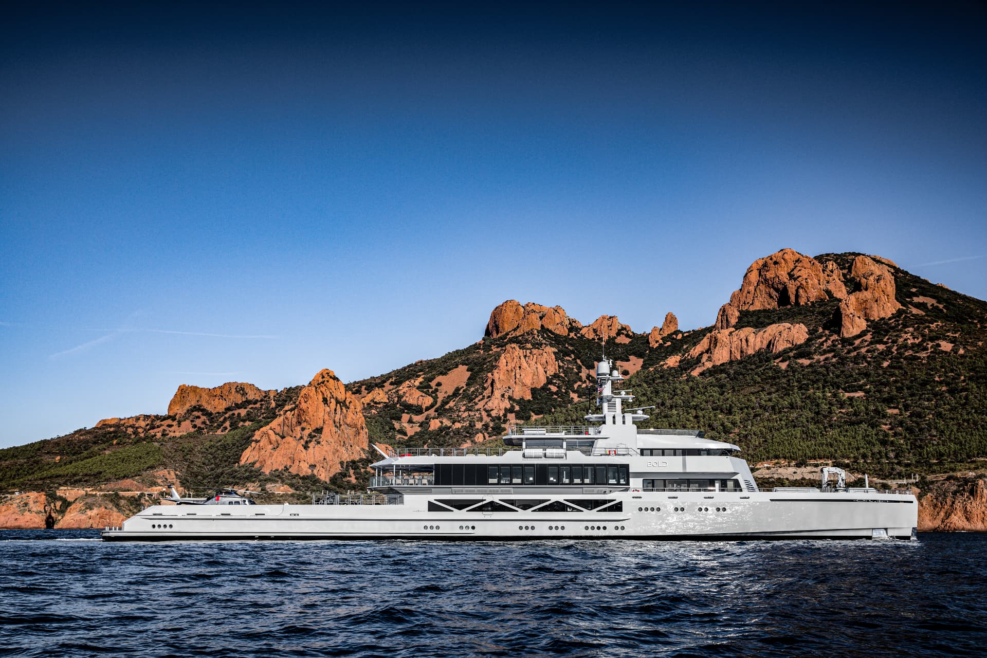 Bold cruising past a dramatic rocky coastline