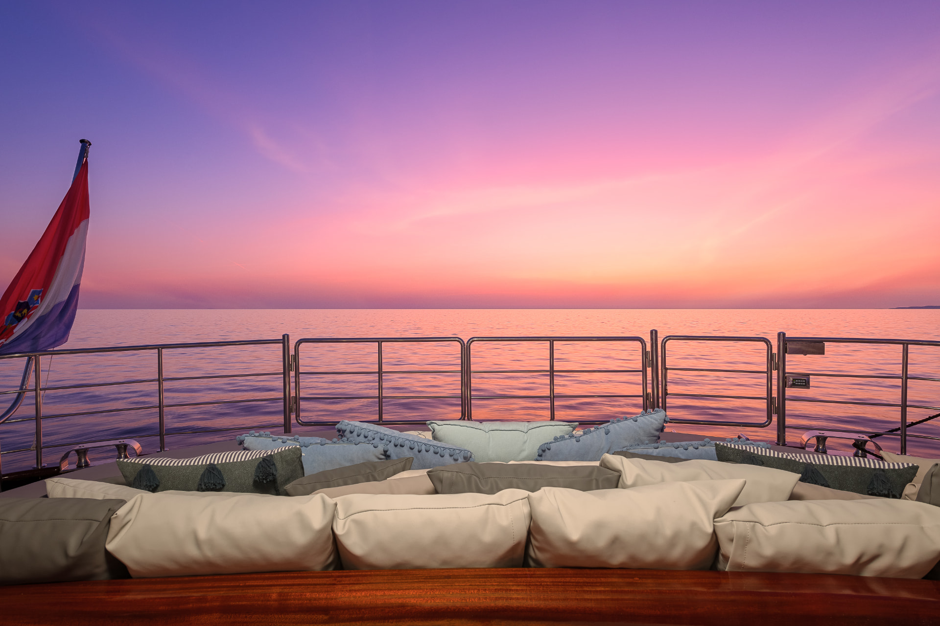 Lady Gita's aft lounge cushions under a pink Adriatic sunset