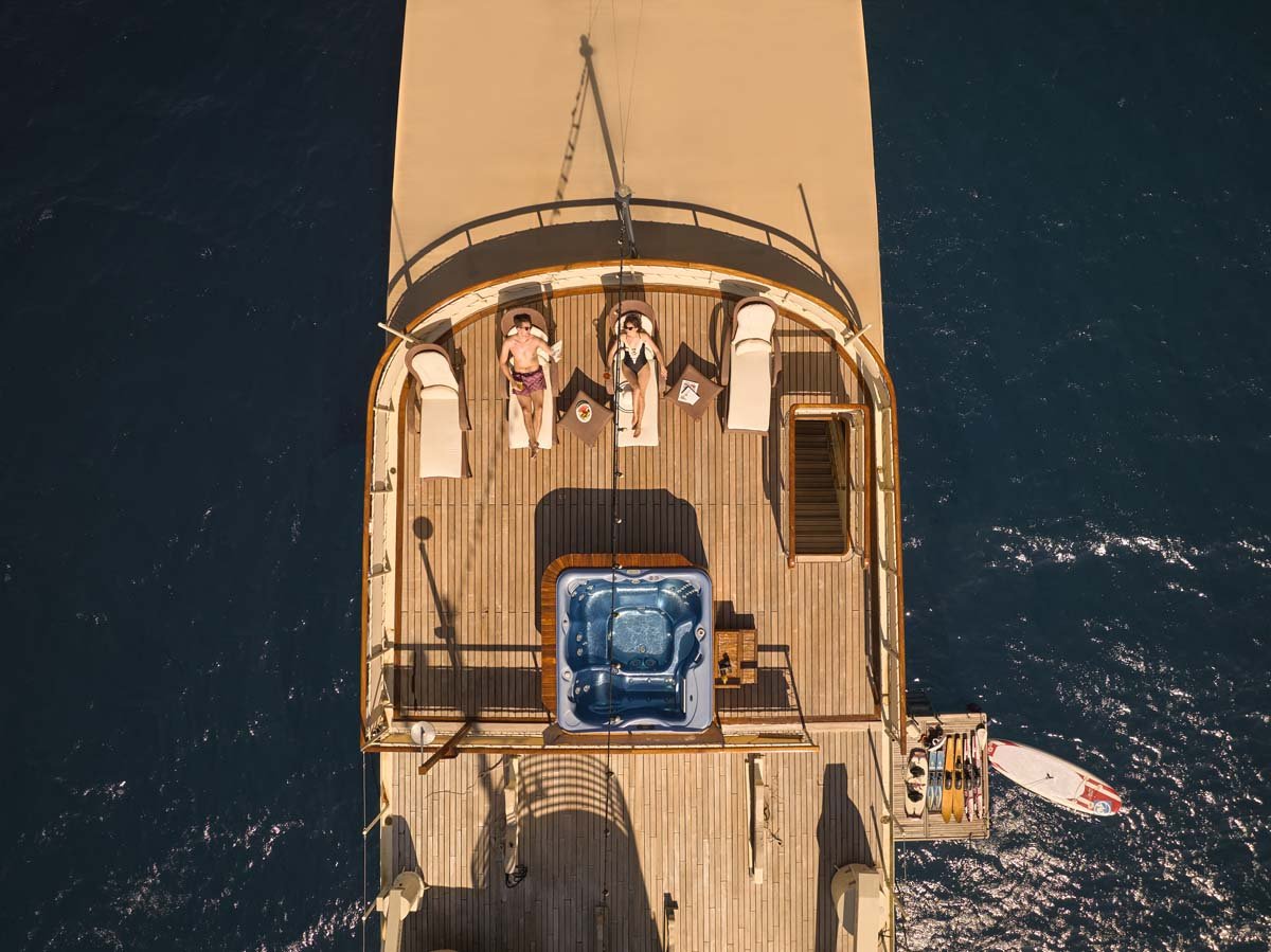 Seagull II's sundeck seen from above with guests at the jacuzzi