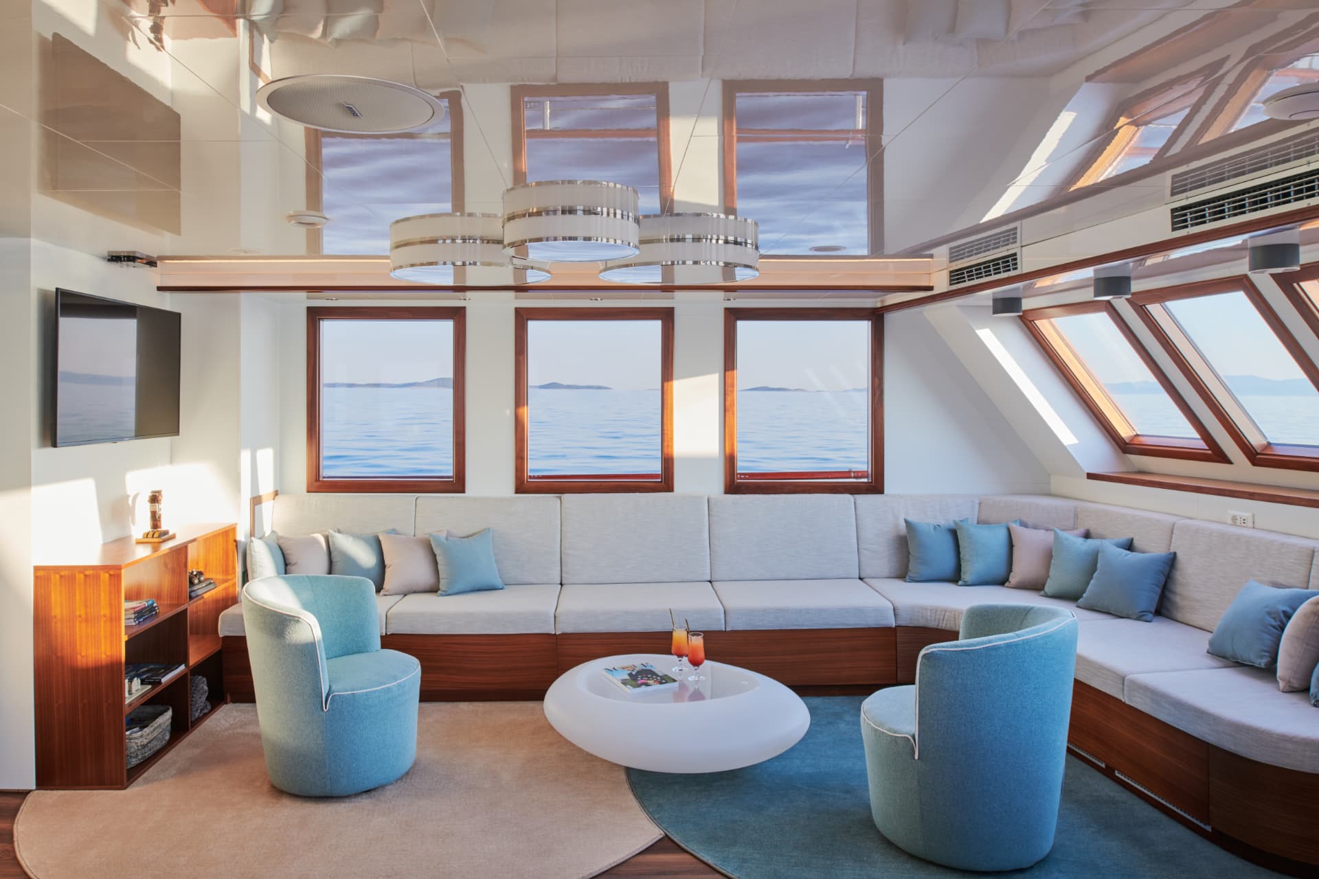 Corsario's light-filled main salon with curved seating
