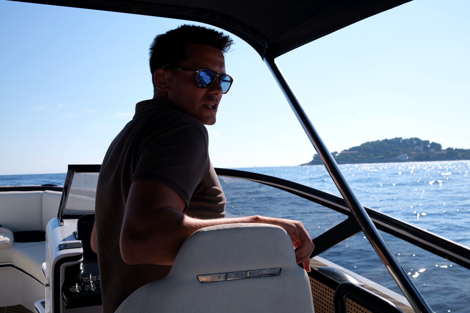 At the helm of the B-Craft Akoya on sparkling blue water off Cap Ferrat