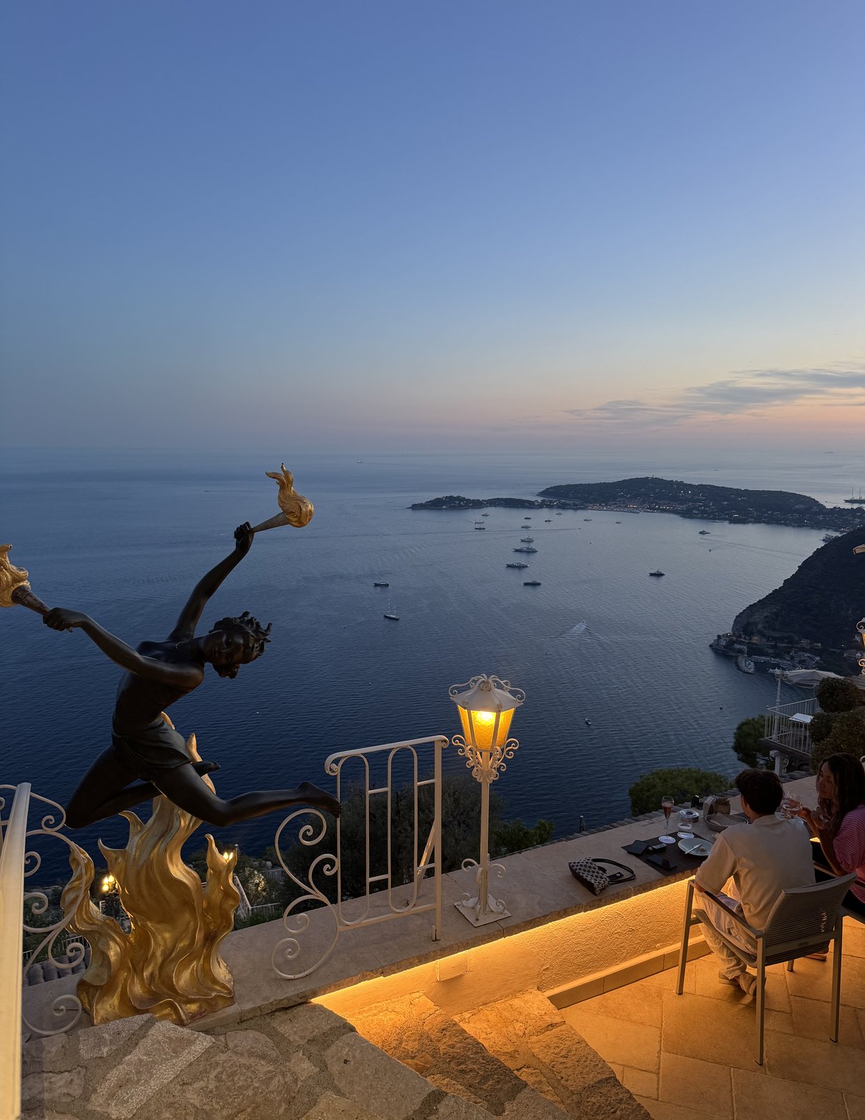 Dusk from a terrace in Èze, looking down over the sea towards Cap Ferrat