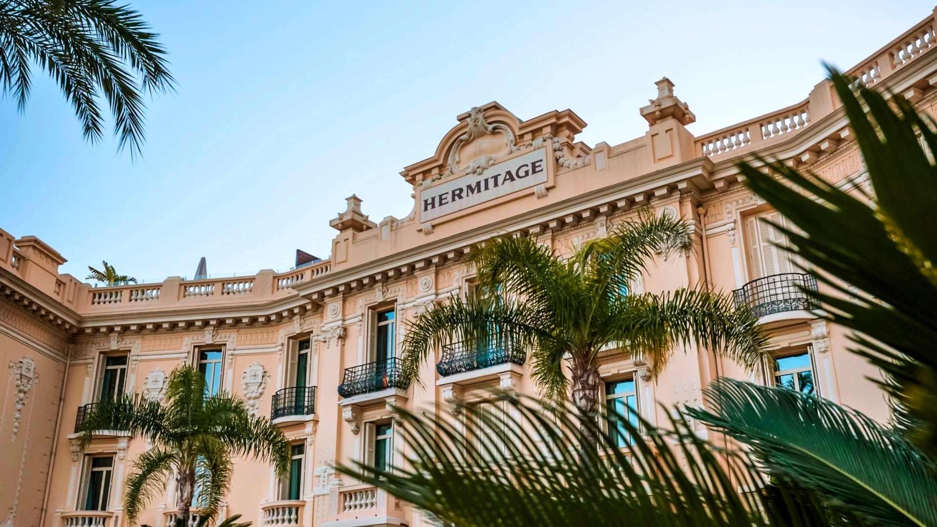 The Belle Époque façade of Hôtel Hermitage Monte-Carlo framed by palms