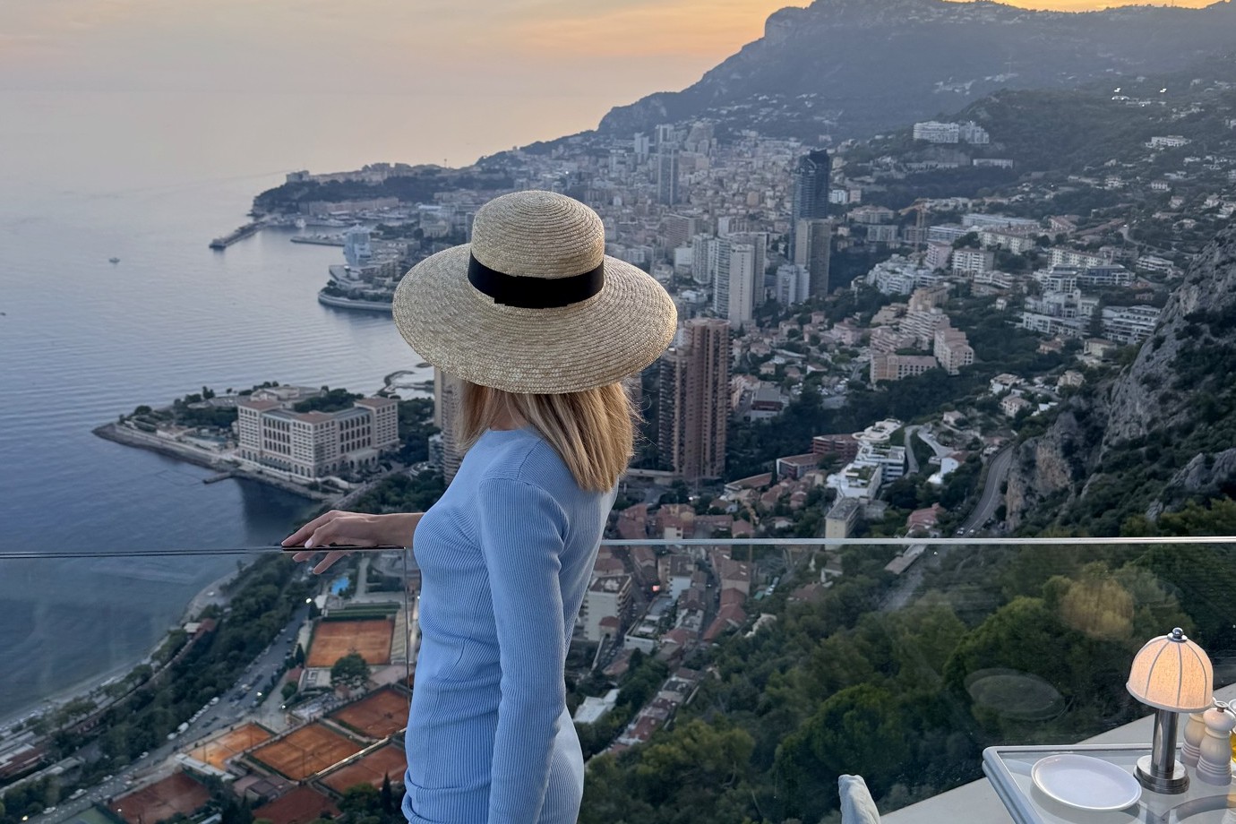 Katarina on the terrace at The Maybourne Riviera at sunset, looking over Monaco