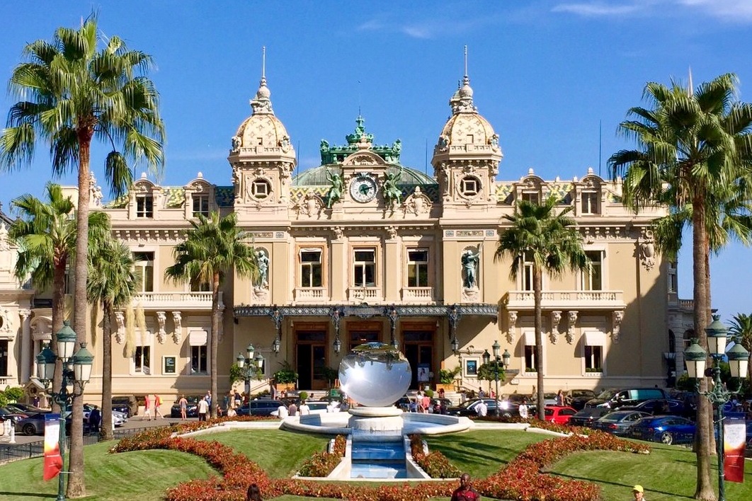 The Casino de Monte-Carlo behind its palms and gardens on a sunny day