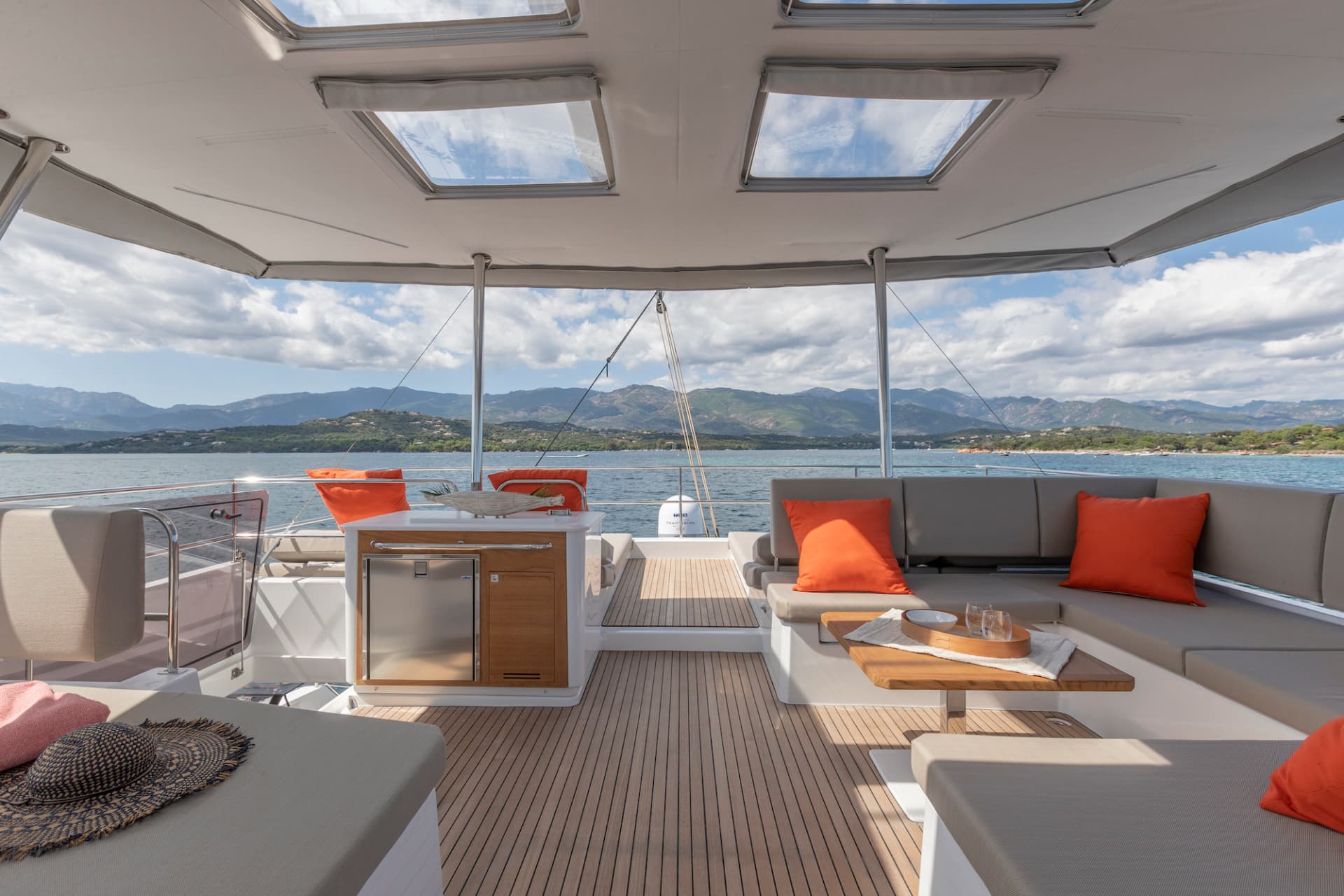 Floramye's open flybridge lounge with mountain views