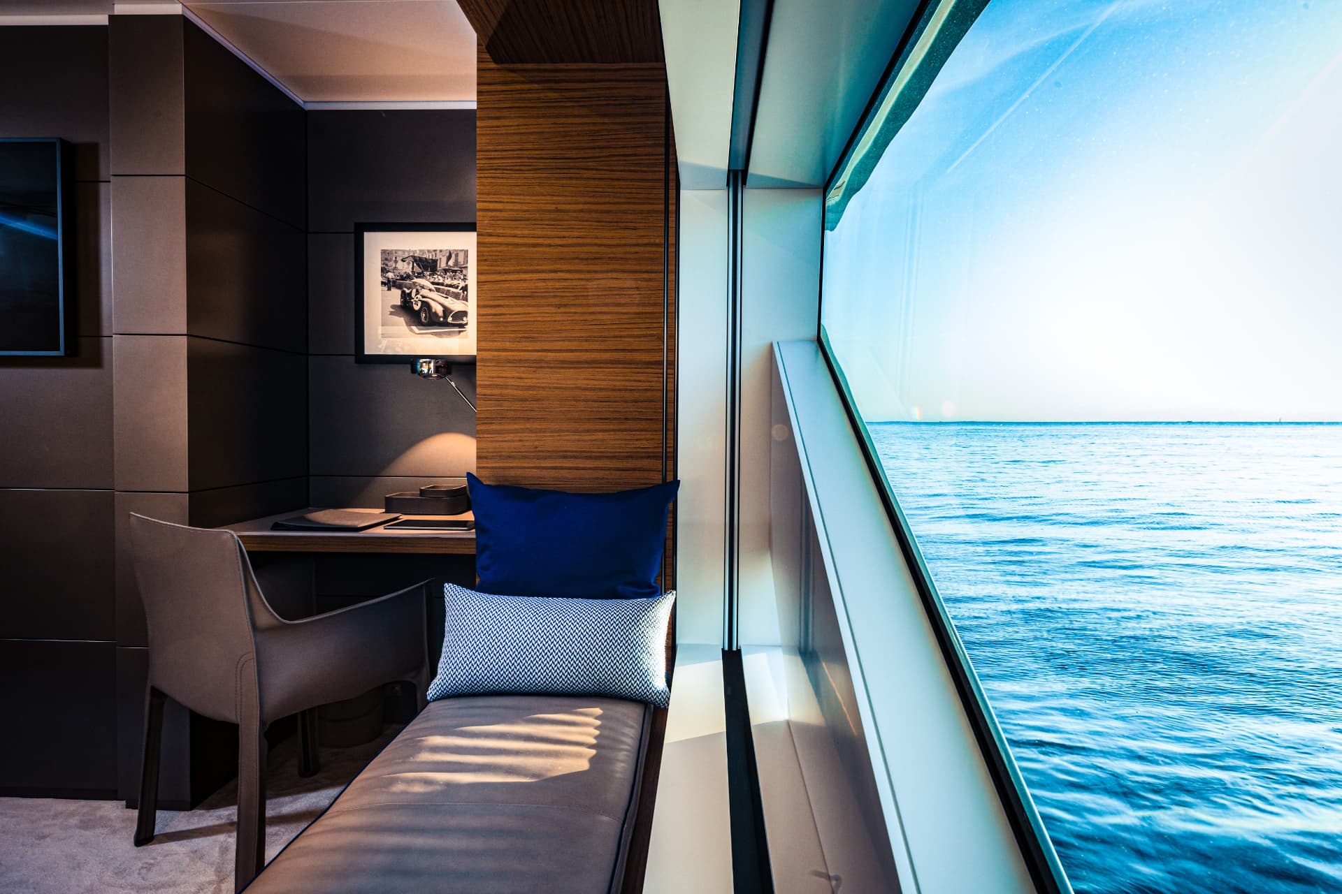Bold guest suite seating beside a panoramic sea-view window