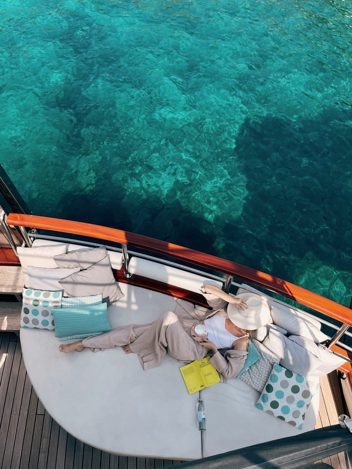 Reading on deck above clear Adriatic water