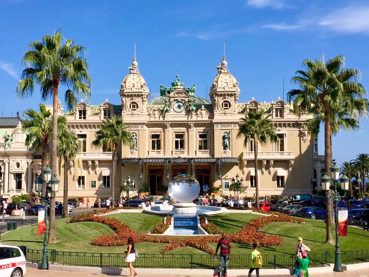 The Casino de Monte-Carlo behind its palms and gardens on a sunny day