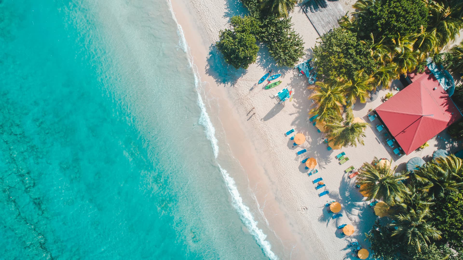 A Caribbean beach and clear turquoise water seen from above