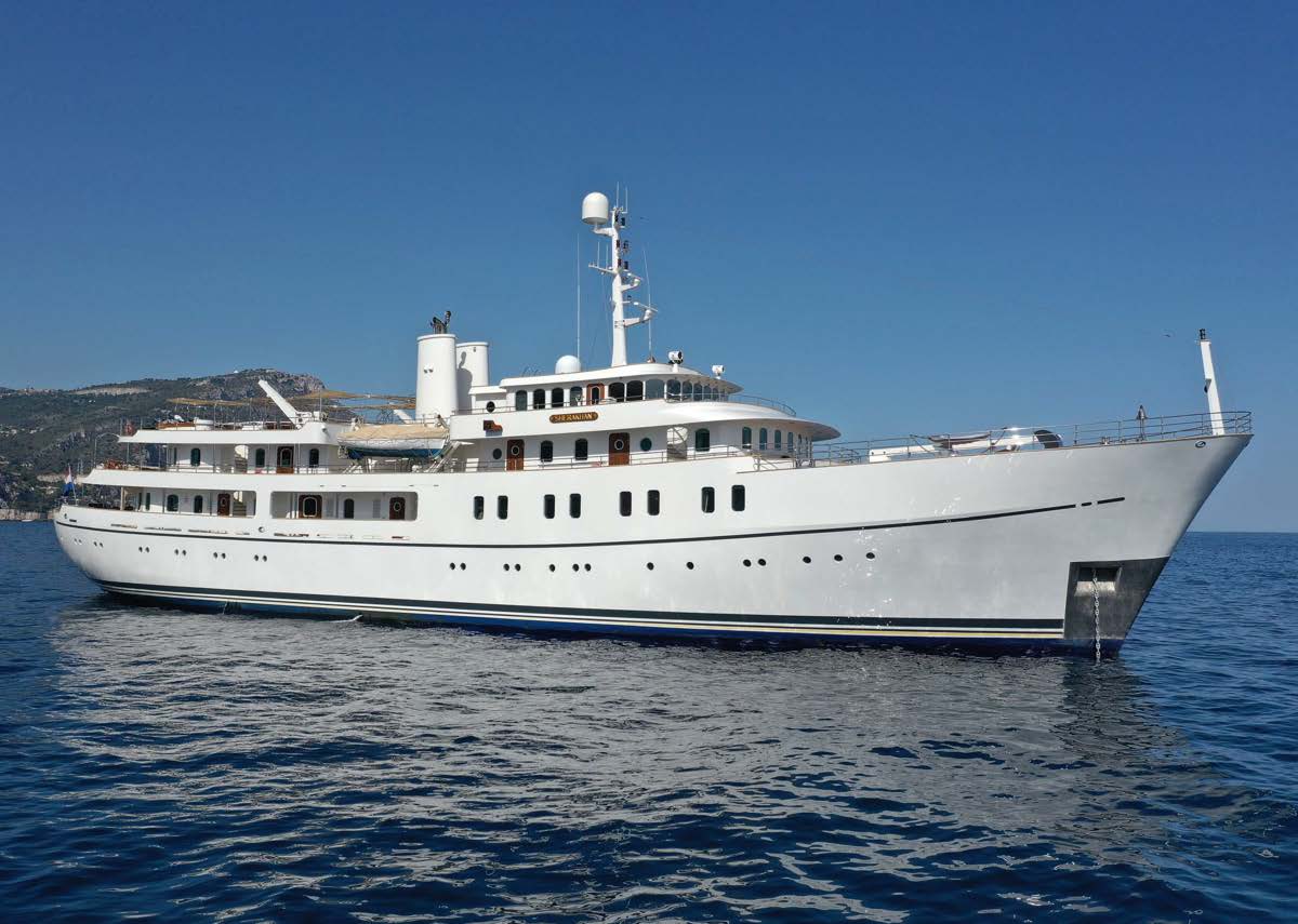 Sherakhan's classic white profile cruising past a green headland