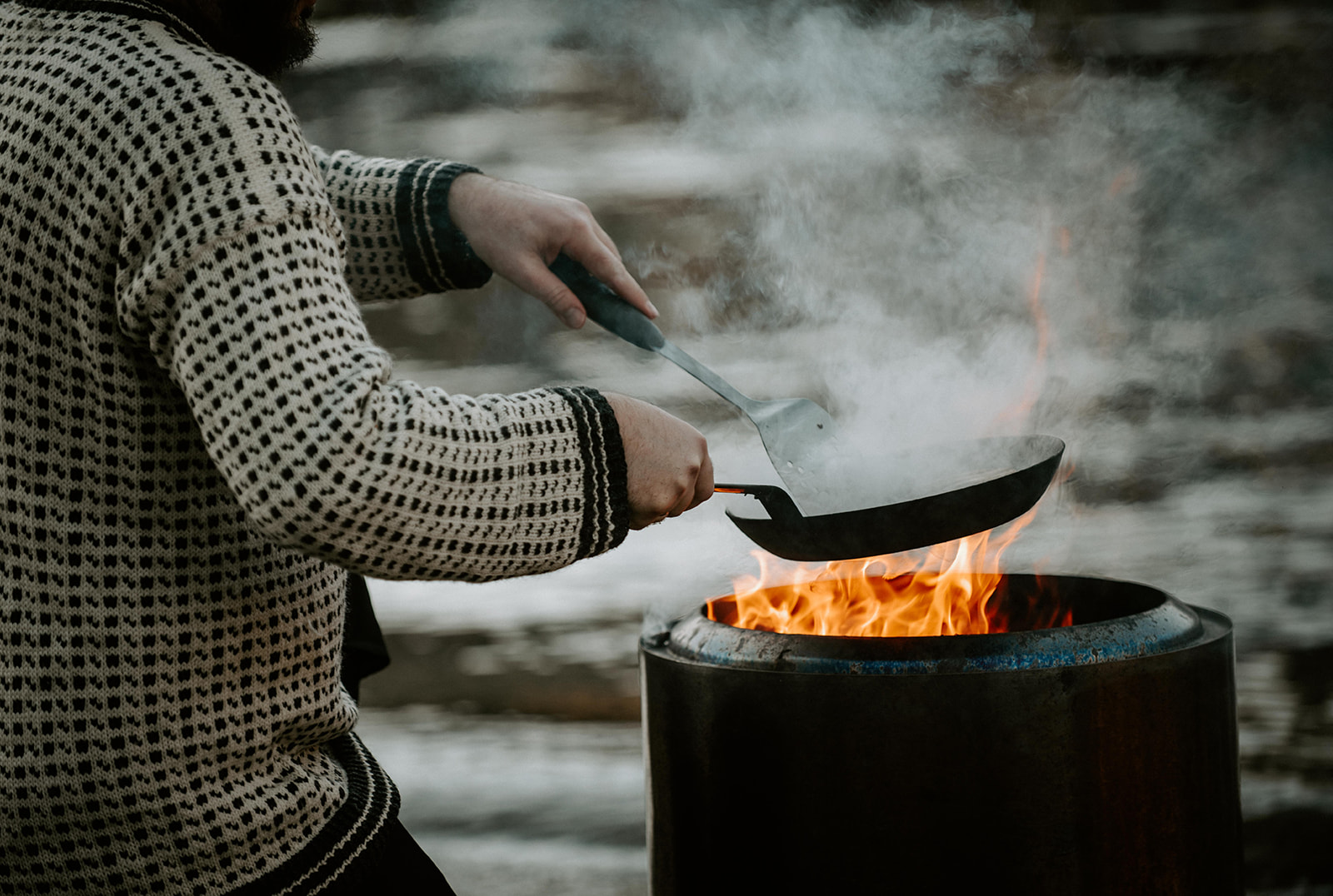 Cooking over an open fire beside a Norwegian fjord
