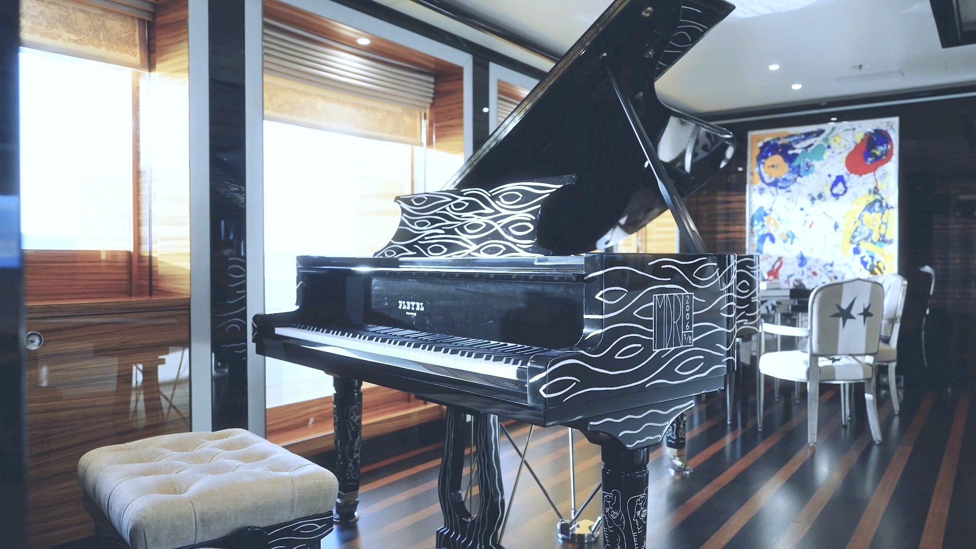 The black-lacquered Pleyel grand piano with its white wave pattern in Alfa Nero's main salon. Photo: Alfa Nero