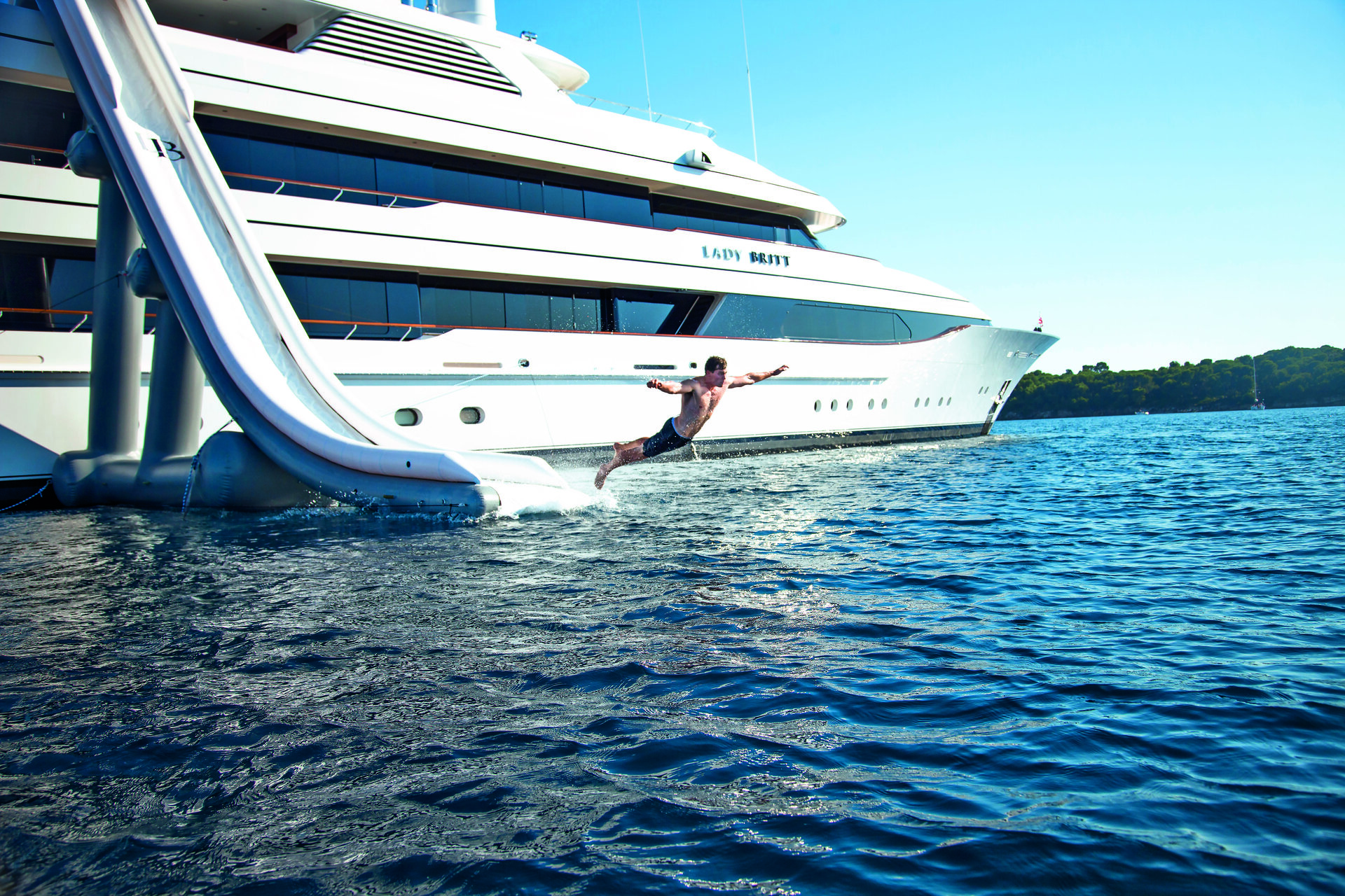Guest sliding into the sea from Lady Britt's waterslide